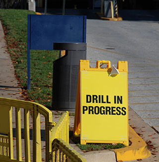 sign on street stating drill in progress