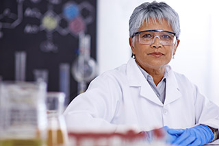 A senior female scientist working in her lab.