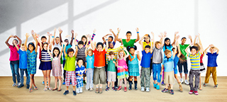 Group of diverse children with arms raised