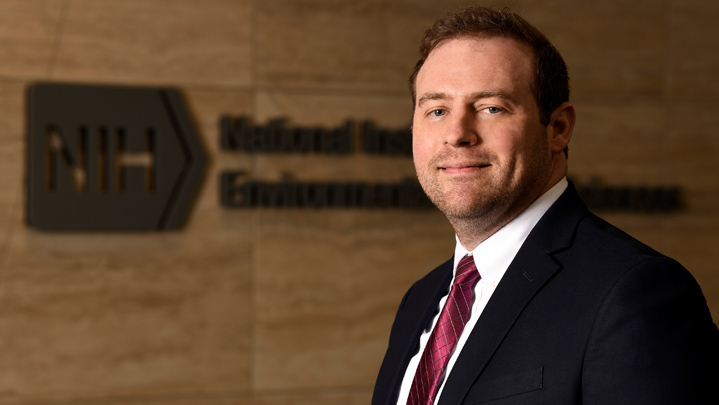 the niehs director speaking at a podium