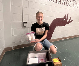 student holding soil sample