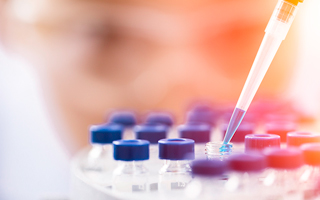 lab worker using droper over tools