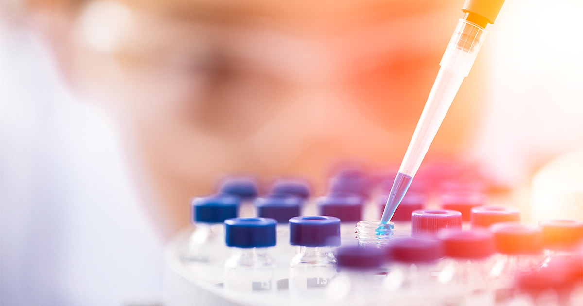 lab worker using droper over tools 