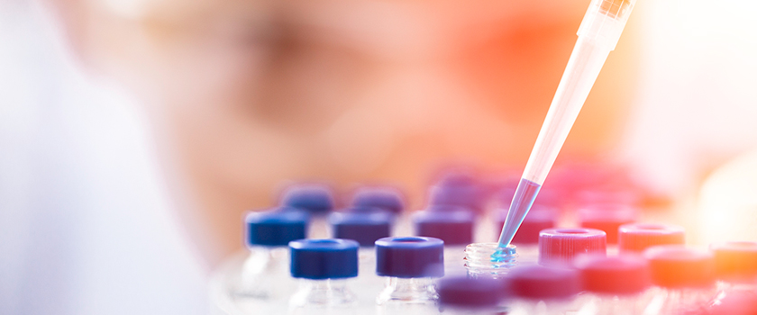 lab worker using droper over tools