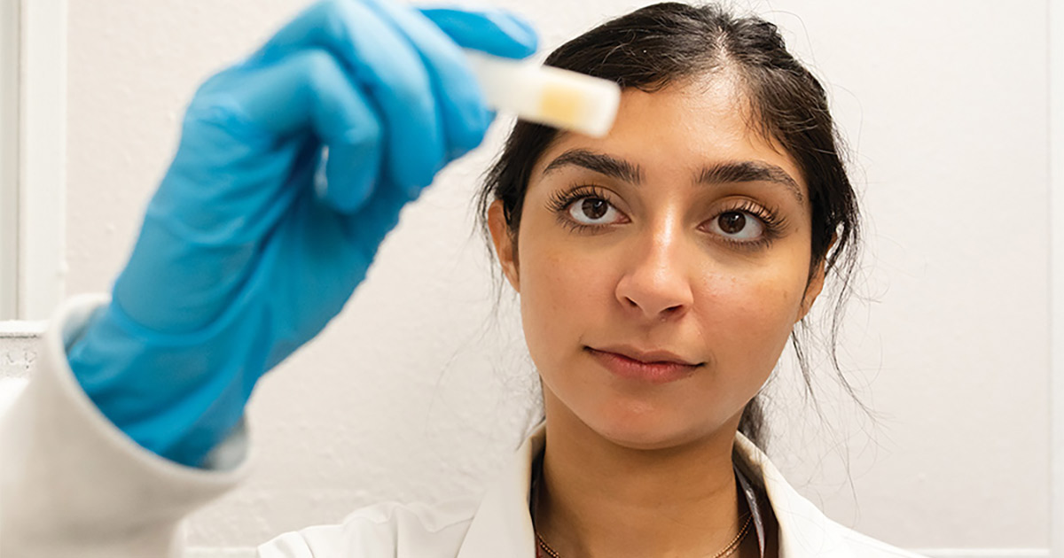 scientist looking at tube