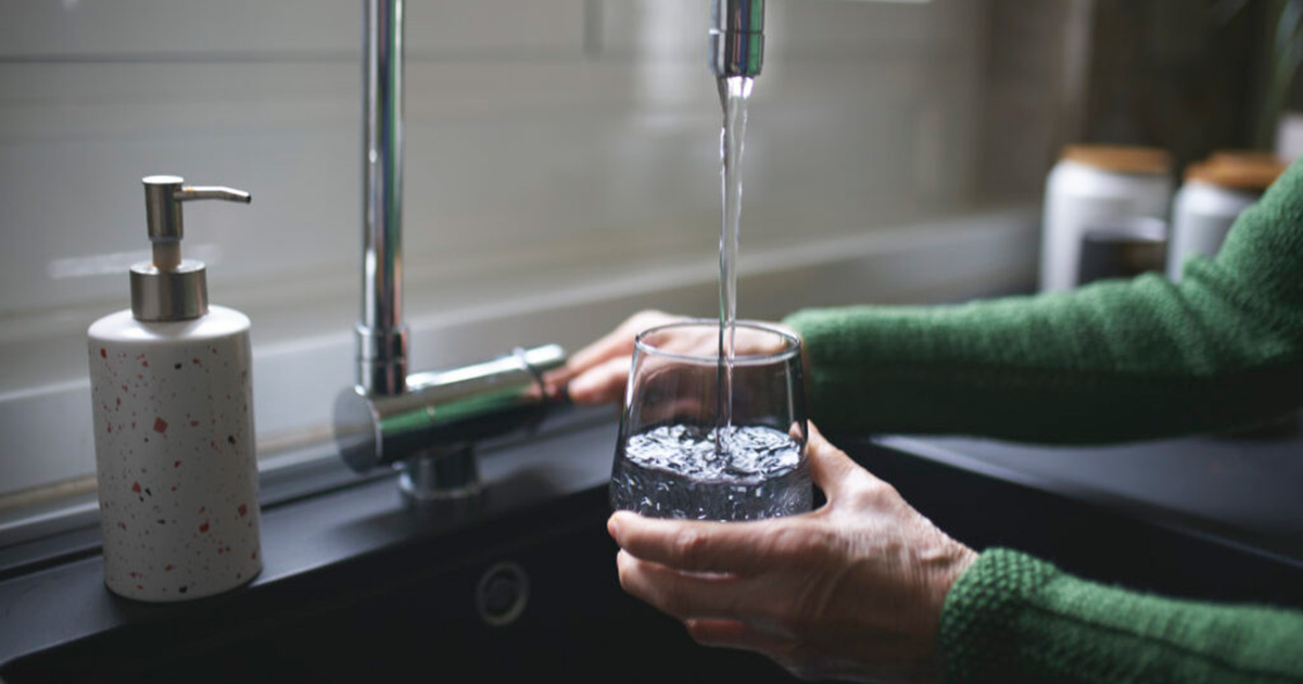 filling a glass of water from a faucet