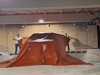 Fire blanket deployed on top of car