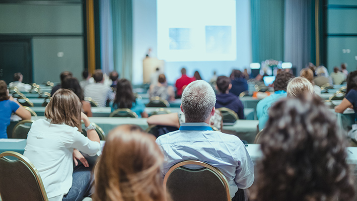 group of people attending a conference in a hall