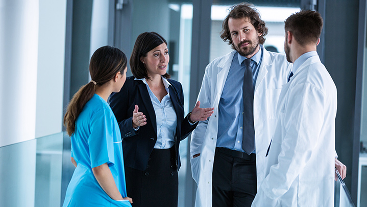 Grooup of scientists talking in a hallway