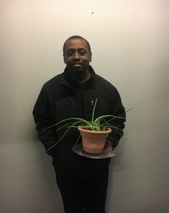 Man holding a potted plant