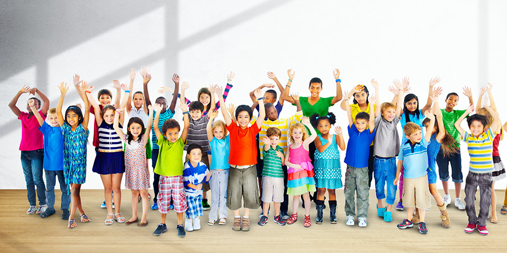 Group of diverse children with arms raised 