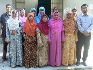 13 men and women posing for a photograph