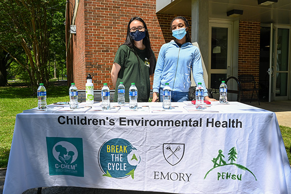 Two students standing by the Children Enviromental Health