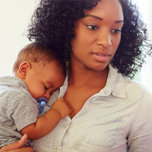 woman holding a sleeping baby