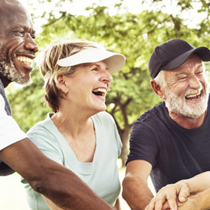 diverse group of older people putting their hands together