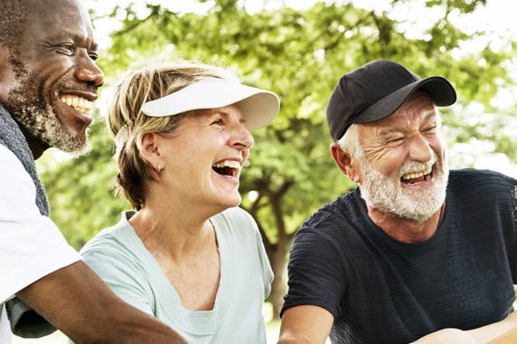 diverse group of older people putting their hands together