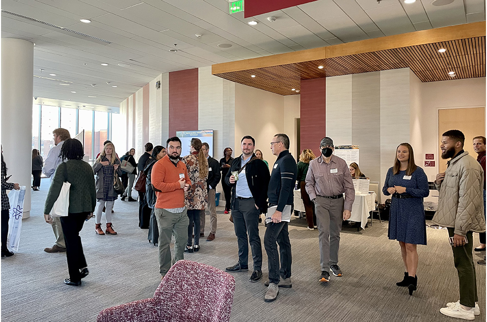 Attendees mingle before the first research presentation began.
