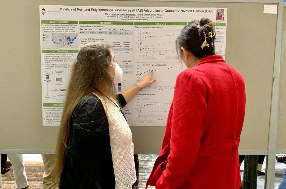 Maria Isabel Alexander Rodriguez and poster session attendee