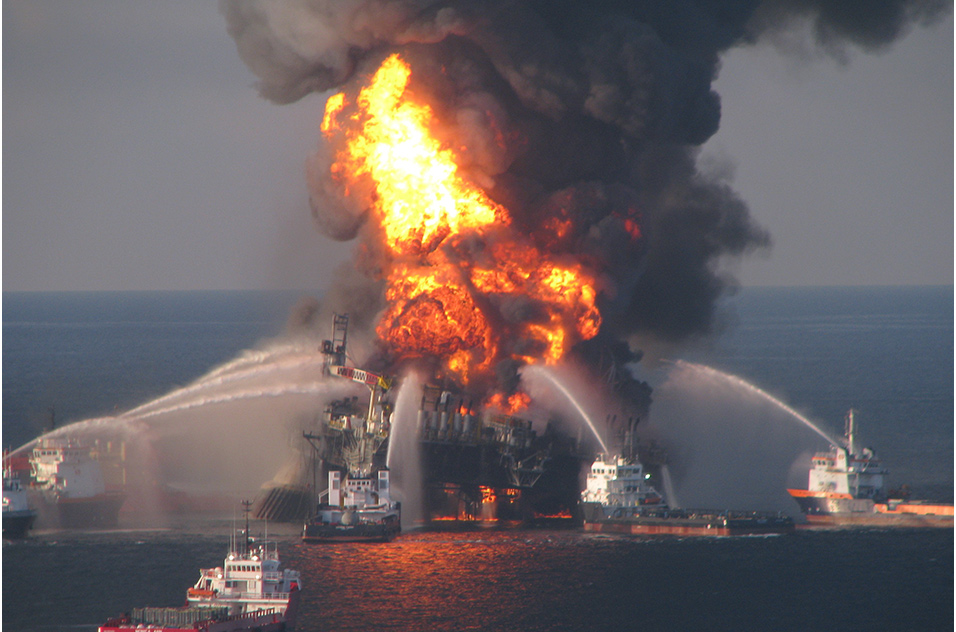 Boats using water to fight fire at drilling unit burning offshore