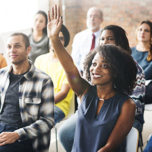 group of happy people sitting at meeting