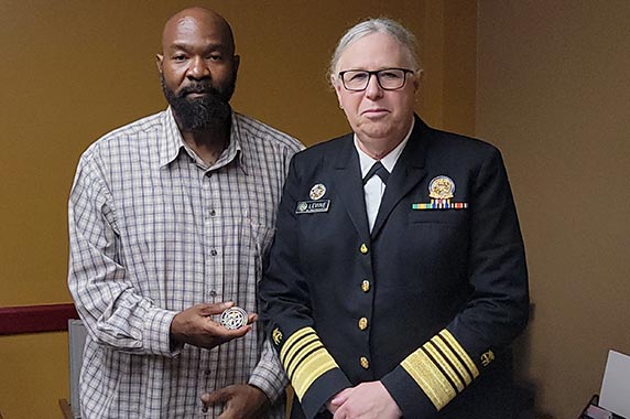 Admiral Rachel Levine, M.D., presents presented Tristan Mack, a worker training program success story, with the U.S. Public Health Service Coin.
