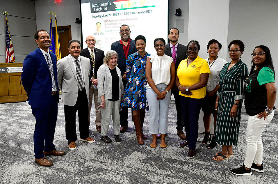 Coble, Hanner, Woychik, and Archer pose with several members of the Juneteenth organizing committee: from left to right, Ruth Lunn, Archer, Beth Perry, Abigail Kitakule, Mbeja Lomotey, Veronica Robinson, Cyrena Silvera, Erika Reid, and Treva Bunch.
