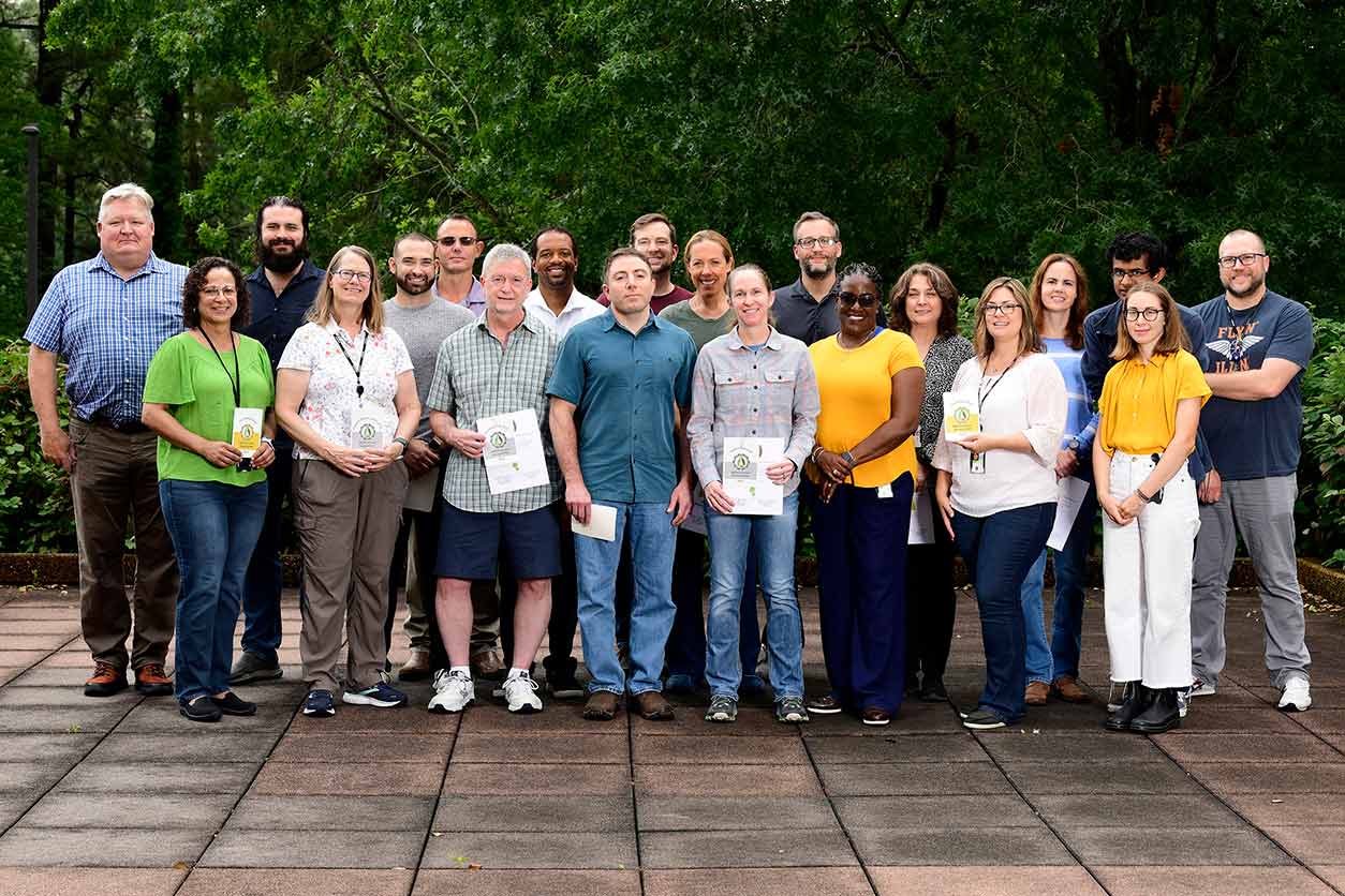 Steve Novak poses for a photo with 2022 and 2023 NIEHS Green Researcher awardees who were present at the ceremony