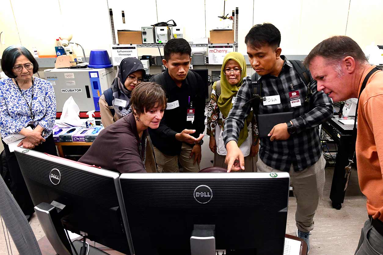 Jeff Tucker, far right, discusses the center’s research with, from left to right, Huei-Chen Lee, Ph.D., Patricia Patrick, Ph.D., Yayuk Oktarina, Ricky Azrofi Samara, Endang Puspa Sari, and Ariyoga Pratama.