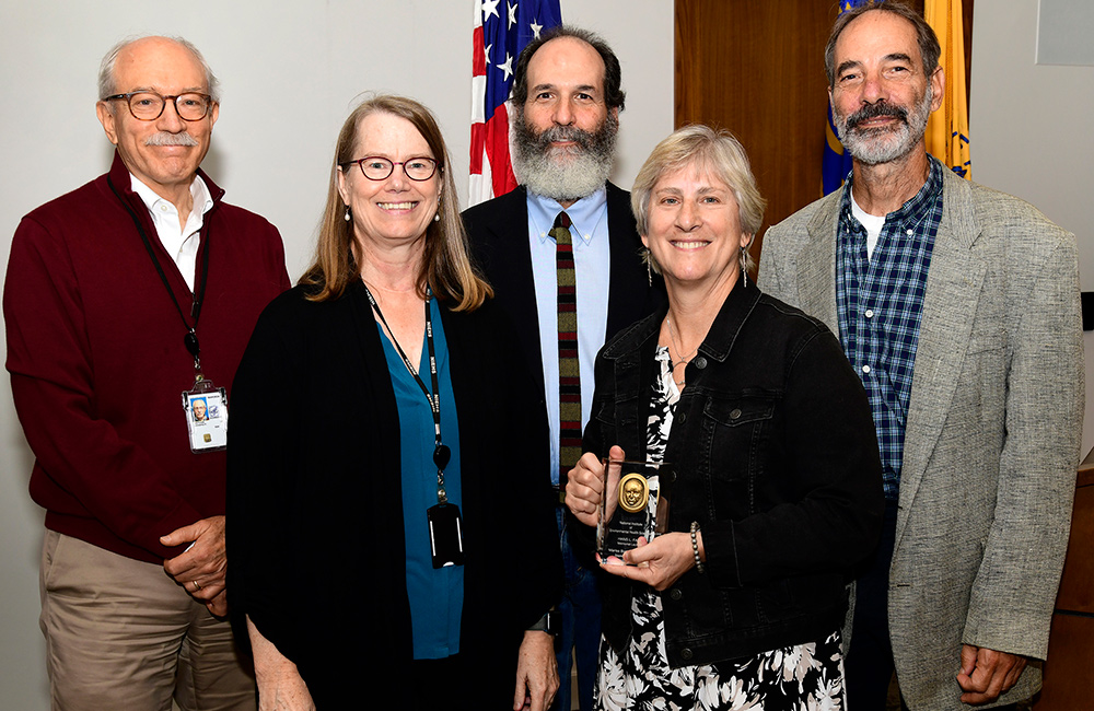 Rick Woychik, Ph.D., Carmen Williams, M.D., Ph.D., and Marisa Bartolomei, Ph.D., with Falk’s sons Stephen Falk and Donald Falk.