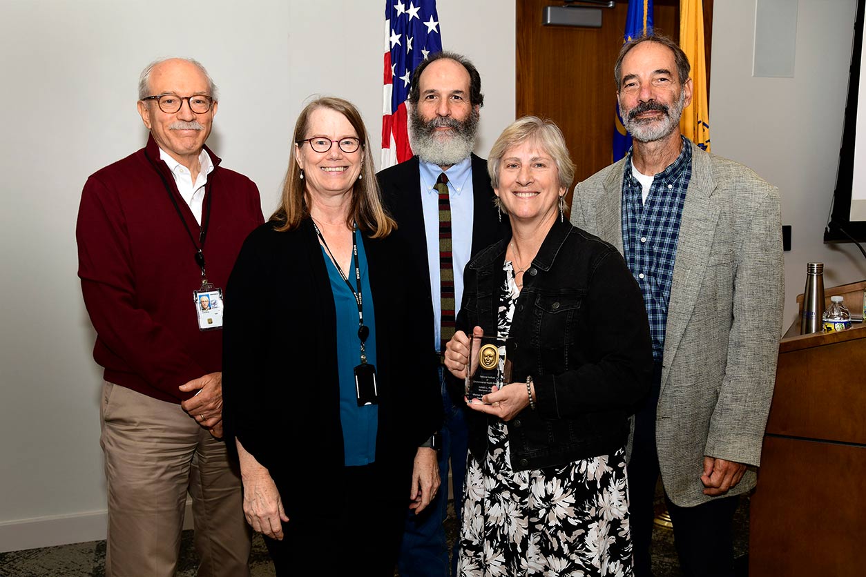 Rick Woychik, Ph.D., Carmen Williams, M.D., Ph.D., and Marisa Bartolomei, Ph.D., with Falk’s sons Stephen Falk and Donald Falk.