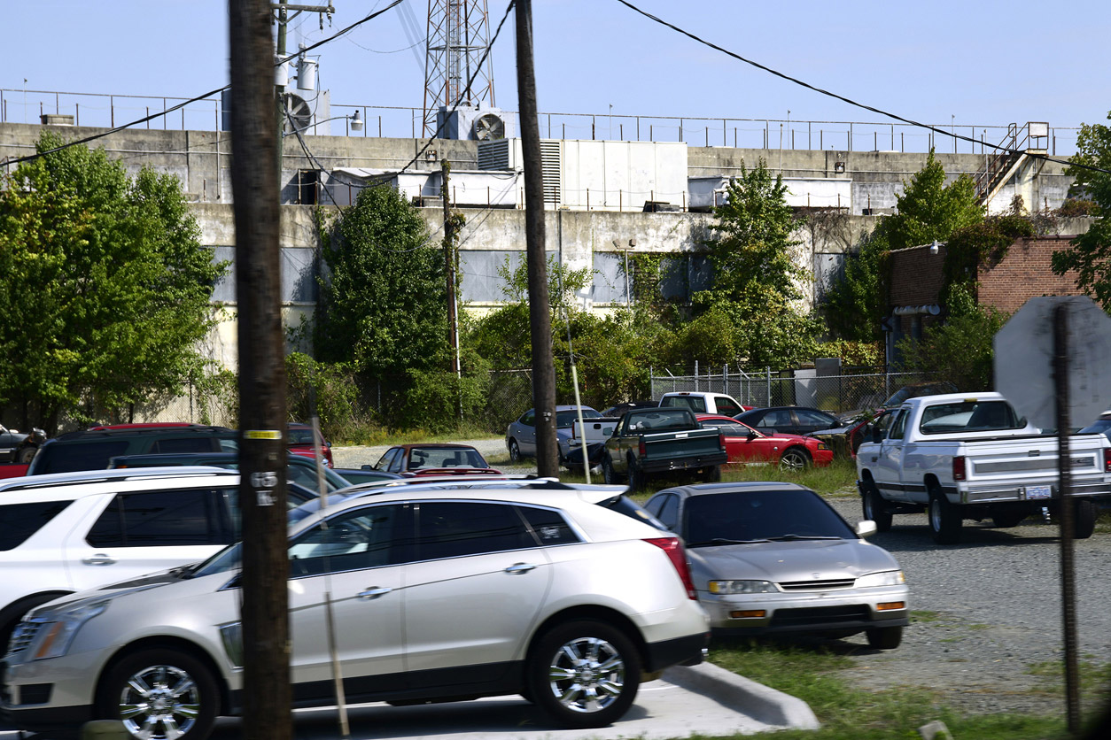 cars parked in front of the abandoned building