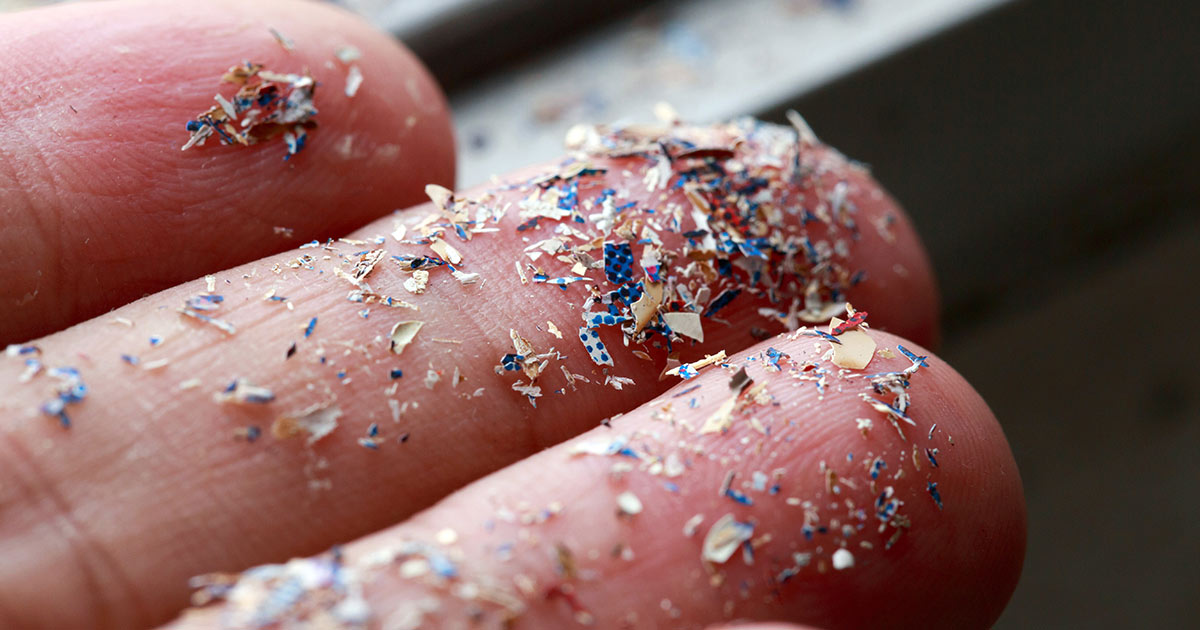 Fingers with microplastics on them
