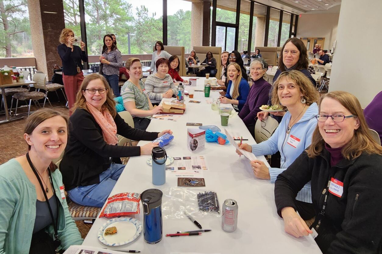 women in science group sitting in NIEHS cafeteria