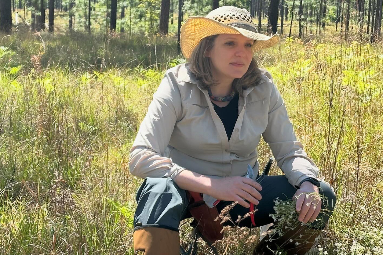 Cassandra Quave, Ph.D. sitting in nature