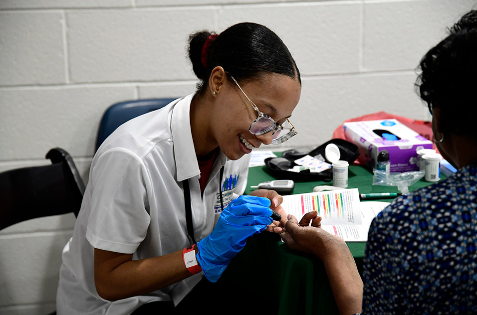 health worker administering a glucose test