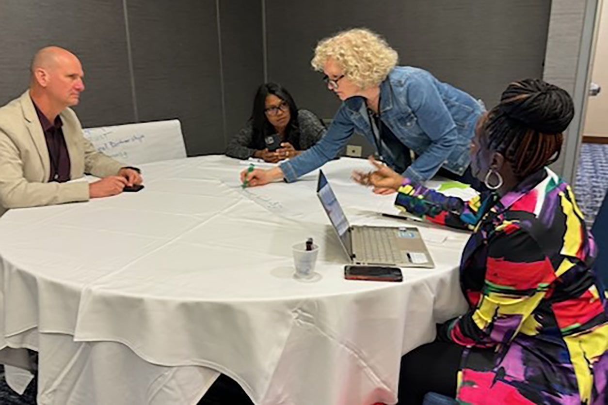 For workshop participants collaborating at a round table with a white tablecloth