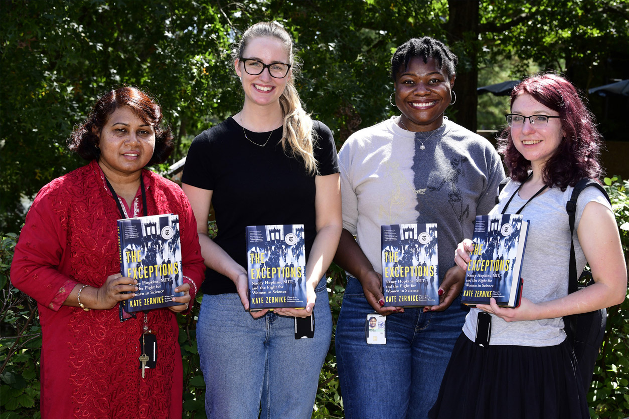 Monsur, McNell, Siegler and Rogers with each a copy of a book