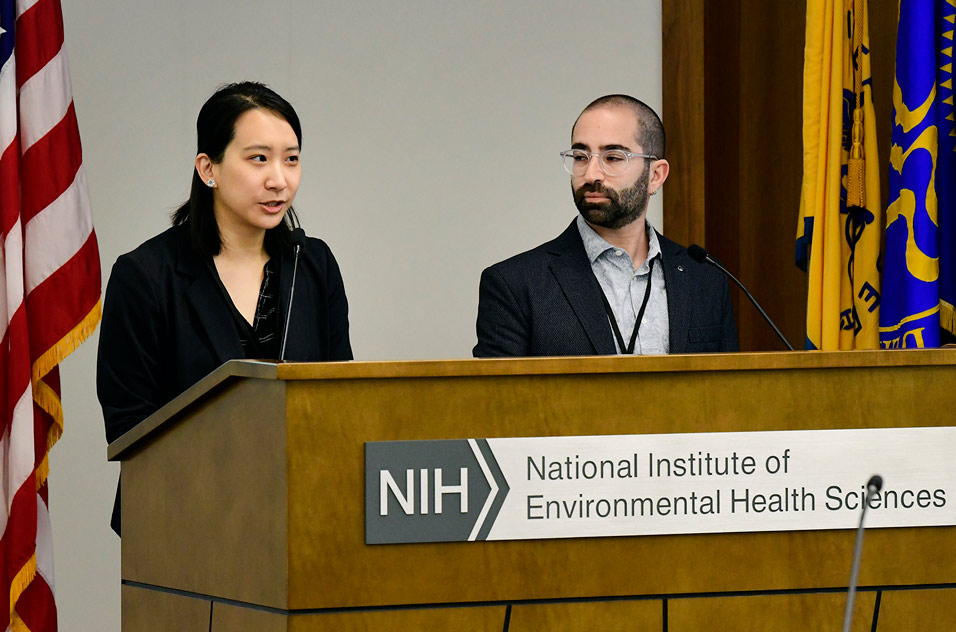 Yu-Ying Chen, Ph.D., left, and Matias Grodzielski, Ph.D., right, speak at the podium