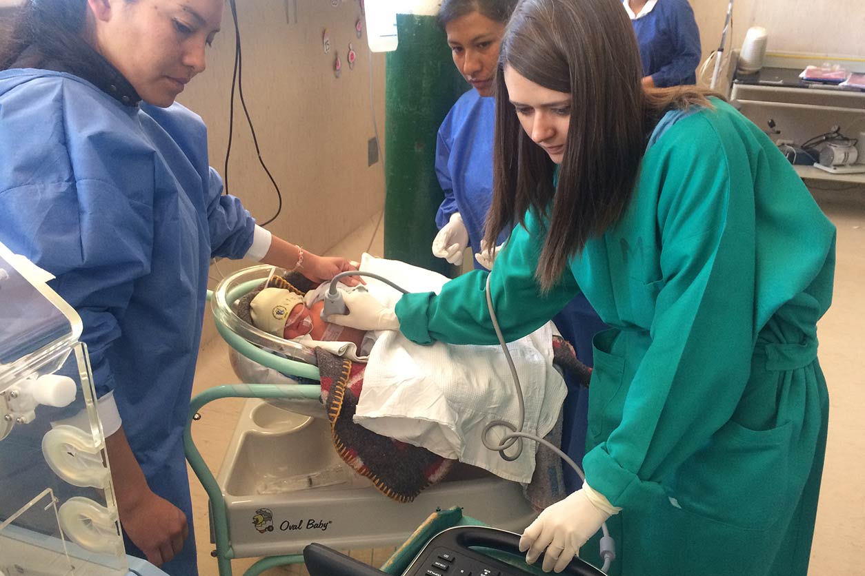 Mary Crocker, M.D., uses an ultrasound to detect an infant’s lung infection for her Fogarty Fellowship research. (Photo courtesy of Mary Crocker).