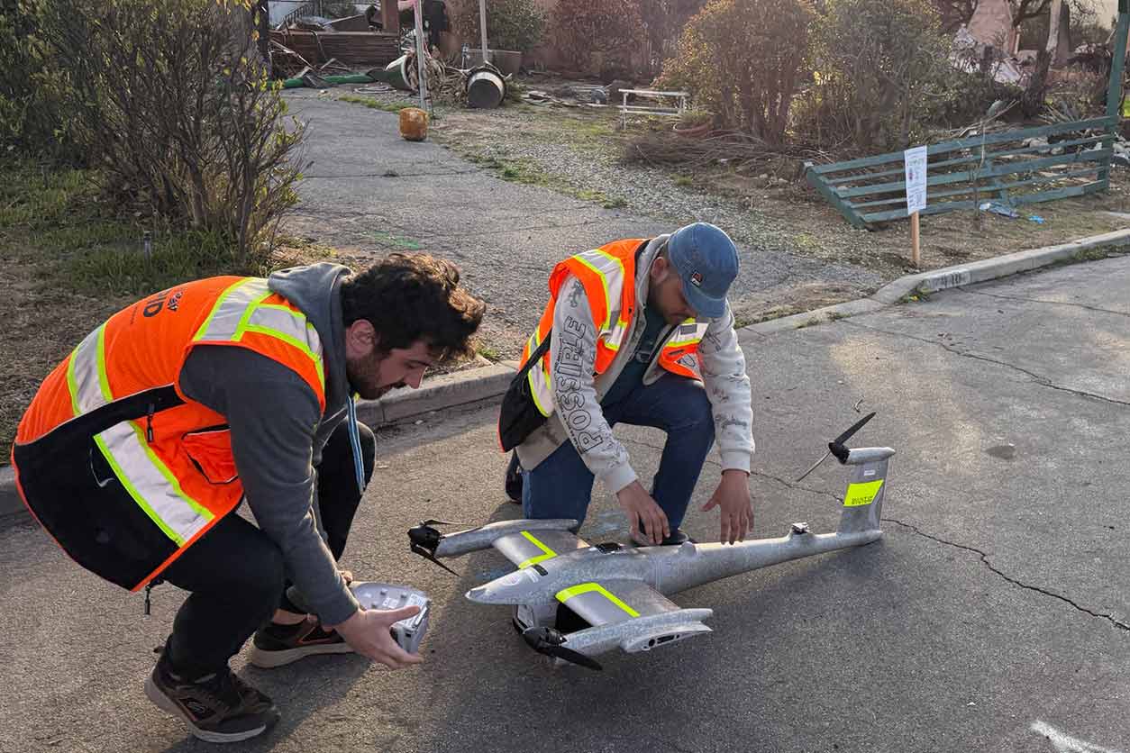 UCLA graduate students prepare a fixed-wing drone in Altadena, Calif. The RAPID Facility helps research teams deploy quickly to set up monitoring equipment, collect environmental samples, and survey affected populations following a disaster. (Photo courtesy of the RAPID Facility)