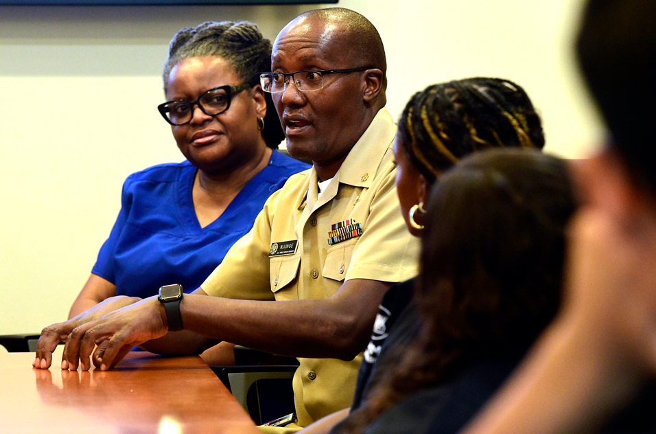 Clinical Nurse Manager Alexander Njunge, center, and Lindia Engram, an occupational health nurse, answer students’ questions
