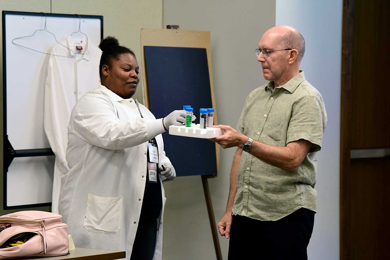 Michael Humble, Ph.D., shows Kayla Williamson-Clements a possible classroom activity for her students at Shepard IB Middle School in Durham, North Carolina.