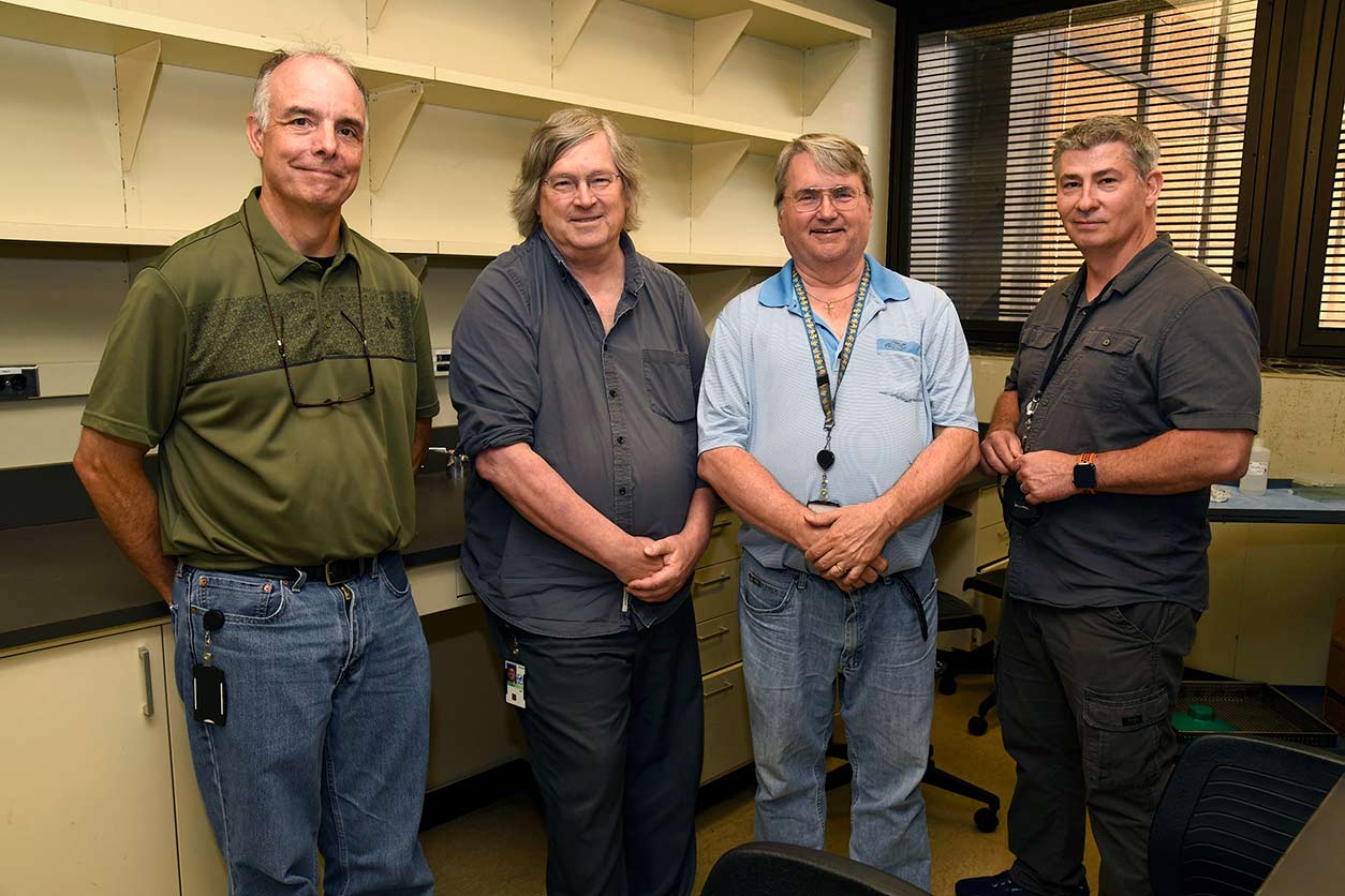 Robert Petrovich, Ph.D., second from right, together with Protein Expression Facility team members Thomas Stanley, left, and Randy Bledsoe, far right, and Thomas Randall, Ph.D., Biostatistics and Computational Biology Branch, led the laboratory exercise at the core of the program.