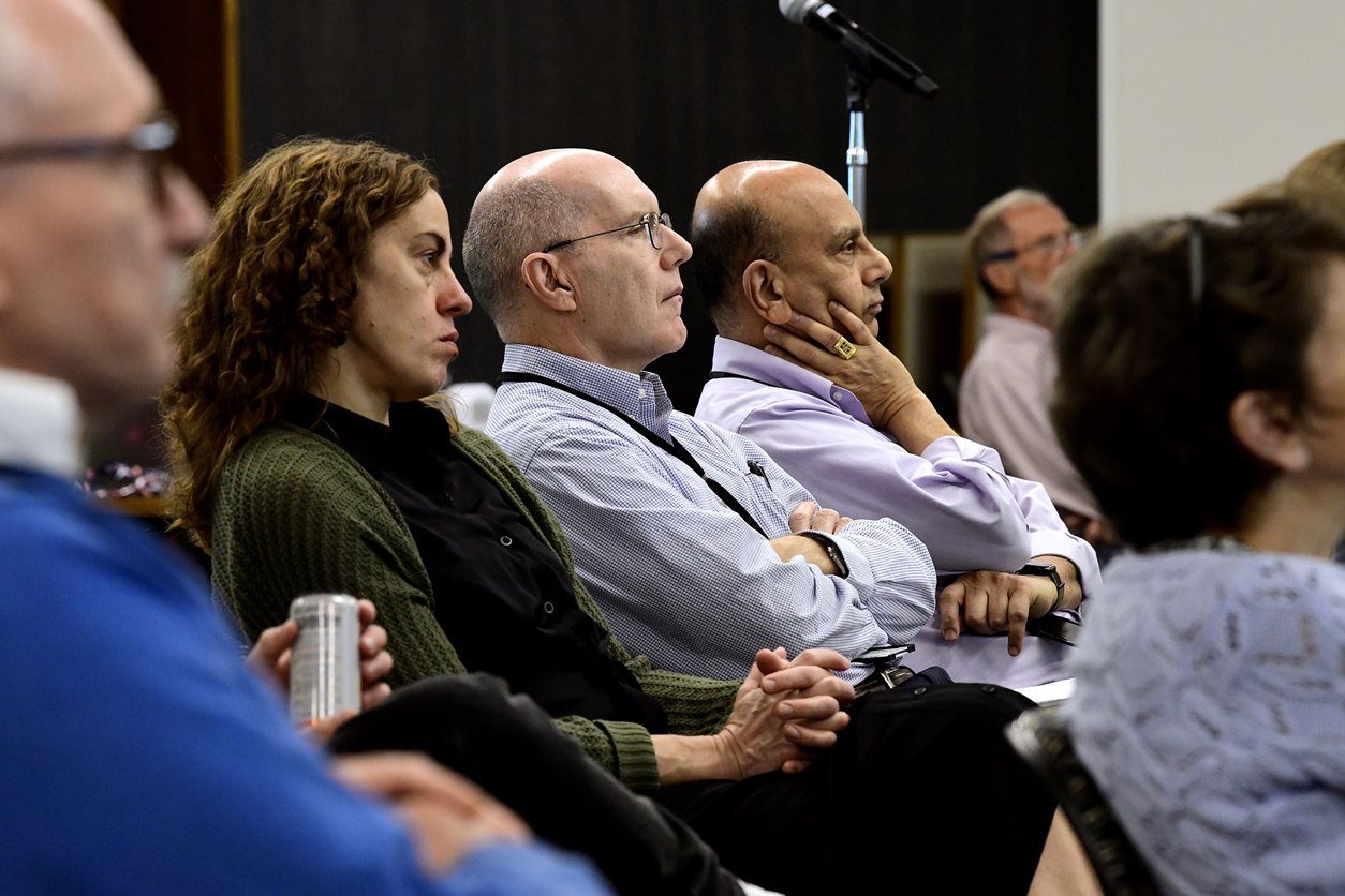 Audience members listening to lecture