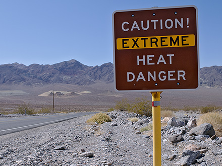 sign in desert reading Caution Extreme Heat Danger