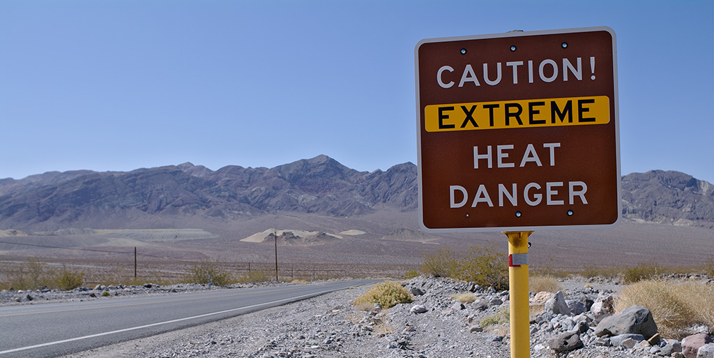 sign in desert reading Caution Extreme Heat Danger