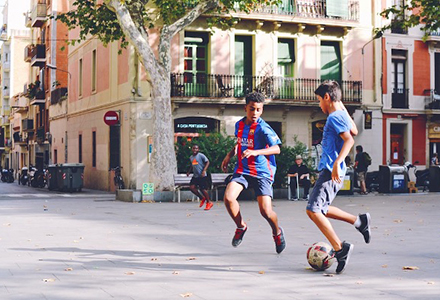 children playing soccer in the street