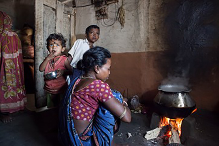 children around an indoor, unvented fireplace