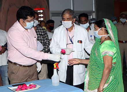 medical personnel handing a flower to a patient