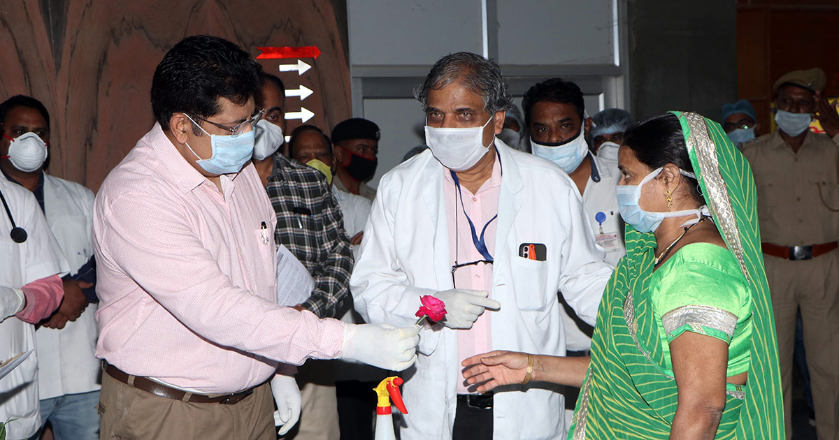 medical personnel handing a flower to a patient